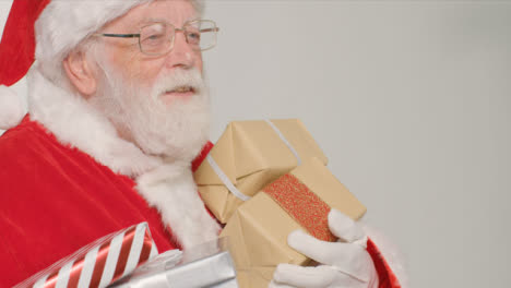 Close-Up-Shot-of-Santa-Holding-Some-Presents-and-Gifts