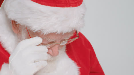Close-Up-Shot-of-Santa-Taking-Off-His-Glasses