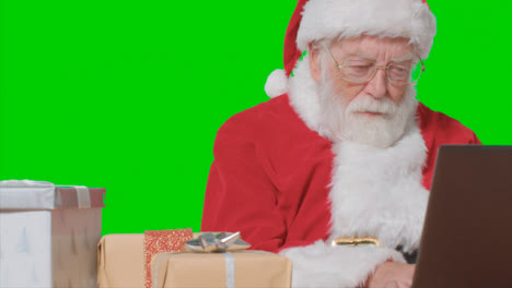 Portrait-Shot-of-Santa-Typing-On-a-Laptop