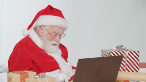 Medium-Shot-of-Santa-Talking-On-Laptop-Video-Call