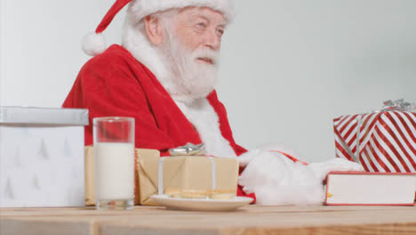 Medium-Shot-of-Santa-Sitting-at-Desk-Talking-Off-Camera