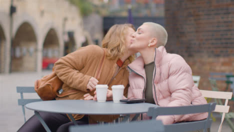 Wide-Shot-of-Young-Woman-Joining-Friend-for-Coffee
