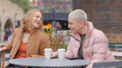 Medium-Shot-of-Young-Woman-Joining-Friend-for-Coffee