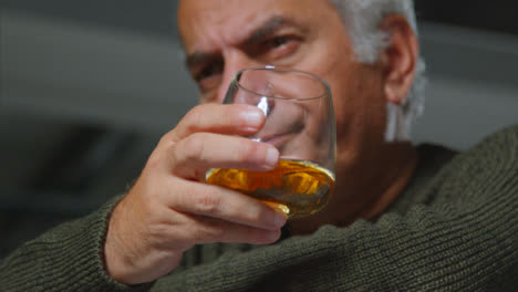 Close-Up-Shot-of-Senior-Man-Drinking-Whiskey