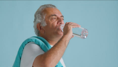Close-Up-Shot-of-a-Senior-Man-Drinking-from-Plastic-Water-Bottle