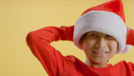 Young-Boy-Putting-on-Santa-Hat