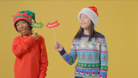 Two-Boys-Holding-Festive-Signs-to-camera