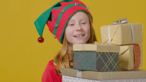 Pull-focus-to-Festive-Girl-Holding-Christmas-Presents