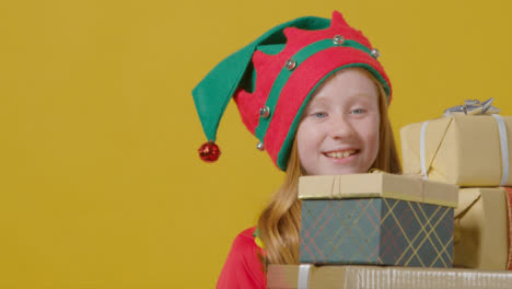 Close-Up-Young-Girl-Walking-Holding-Christmas-Presents