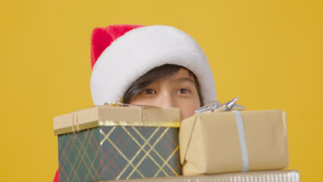 Close-Up-Boy-Peeping-Over-Christmas-Presents