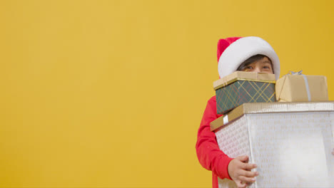Mid-Shot-of-Boy-Walking-Holding-Christmas-Presents