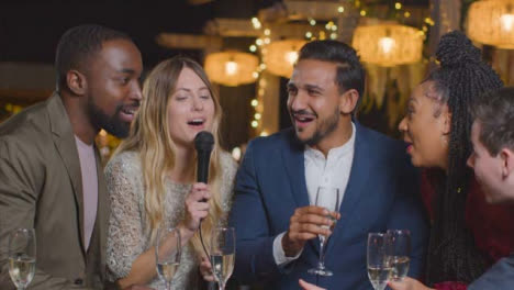 Sliding-Shot-of-Some-Friends-Singing-Group-Karaoke-During-New-Years-Celebrations