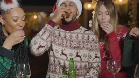 Tracking-Shot-of-Friends-Drinking-Shots-at-a-Bar-During-Christmas-Celebrations
