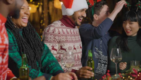 Tracking-Shot-of-Drunk-Man-with-His-Friends-During-Christmas-Celebrations-at-Bar
