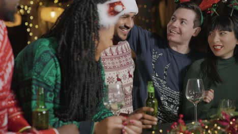 Tracking-Shot-of-Drunk-Man-with-His-Friends-During-Christmas-Celebrations-at-Bar