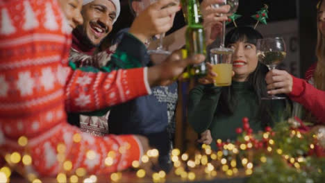 Low-Angle-Shot-of-a-Drunk-Man-with-His-Friends-During-Christmas-Celebrations-at-a-Bar