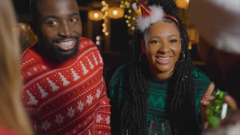 Tracking-Shot-Around-Small-Group-of-Friends-Celebrating-Christmas-at-a-Bar