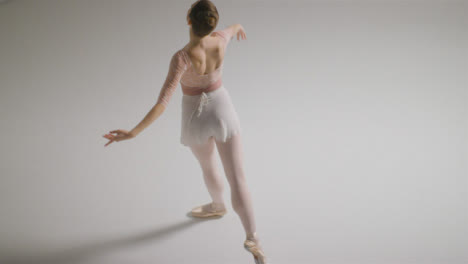 High-Angle-Shot-of-Ballet-Dancer-Jumping-and-Spinning