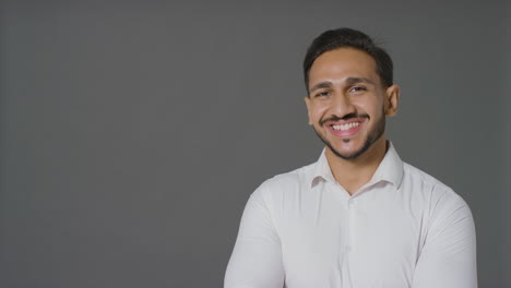 Portrait-Shot-of-Young-Man-Smiling-to-The-Camera-with-Copy-Space