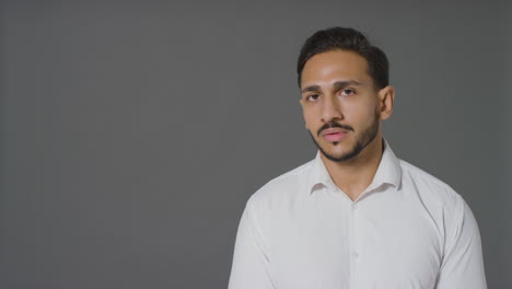 Portrait-Shot-of-Young-Adult-Man-with-Neutral-Expression-with-Copy-Space