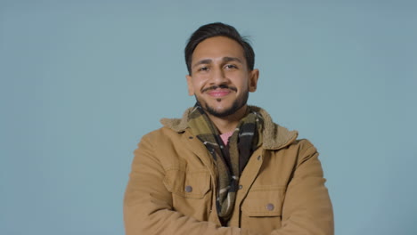 Portrait-Shot-of-Young-Man-Smiling-with-a-Coat-On