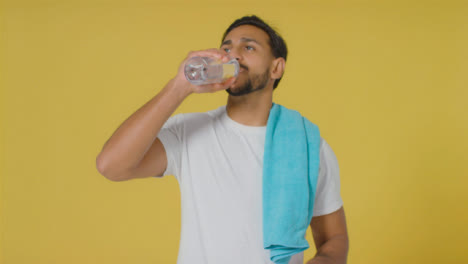 Mid-Shot-of-Young-Man-Drinking-Water