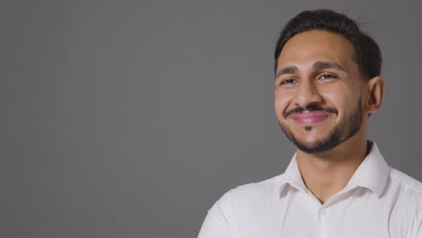 Portrait-Shot-of-Young-Man-Smiling-Away-From-Camera-with-Copy-Space