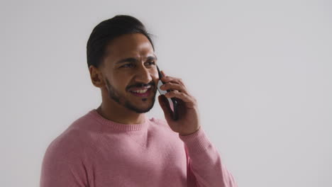 Mid-Shot-of-Man-Speaking-on-Phone-and-Smiling