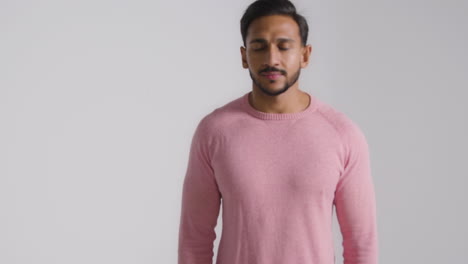 Tracking-Shot-of-Young-Man-Stood-then-Smiling-at-Camera