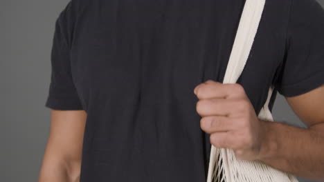Pedestal-Shot-of-Man-With-Bag-of-Vegetables-Over-His-Shoulder