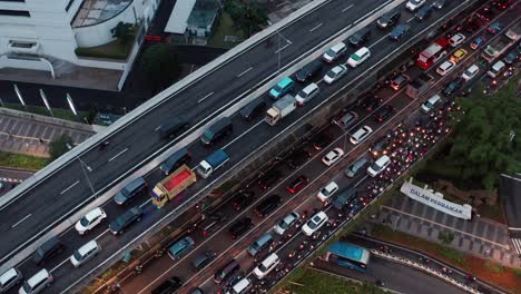 Drone-Shot-Orbiting-Traffic-On-a-Jakarta-Highway