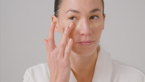 Tracking-Shot-of-a-Young-Woman-Applying-Concealer