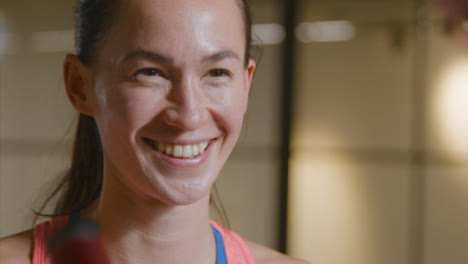 Close-Up-Shot-of-Woman-Talking-and-Smiling-at-Gym