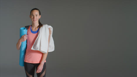 Wide-Shot-of-Young-Woman-Carrying-Gym-Stuff-with-Copy-Space