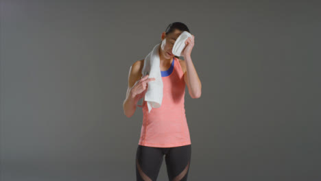 Wide-Shot-of-Woman-Wiping-Sweat-and-Drinking-Water