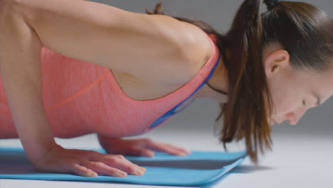 Close-Up-Shot-of-a-Woman-Working-Out-on-Yoga-Mat-