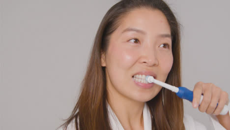 Tracking-Shot-of-Woman-Brushing-Teeth-and-Smiling