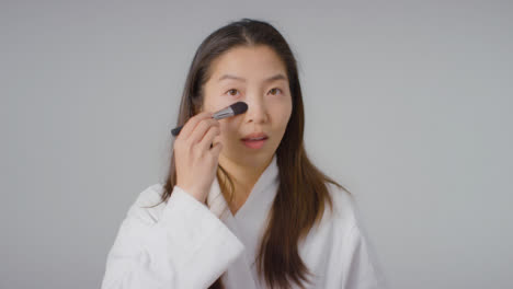 Mid-Shot-of-a-Young-Woman-Applying-Foundation