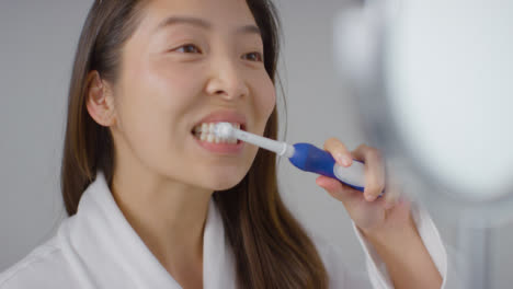 Close-Up-Shot-of-Young-Woman-Brushing-Teeth-and-Smiling