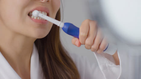 Close-Up-Shot-of-Woman-Brushing-Teeth-Then-Inpsecting-Them