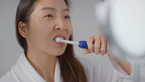 Close-Up-Shot-of-Woman-Putting-Toothpaste-onto-Brush-then-Brushing-Teeth