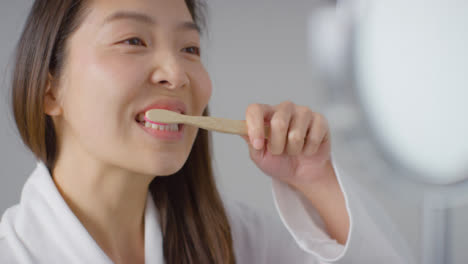 Close-Up-Shot-of-a-Woman-Brushing-Teeth-and-Smiling
