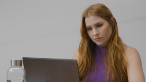 Tracking-Shot-of-Woman-Working-on-Her-Computer