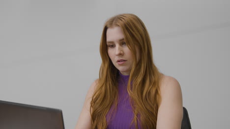 Mid-Shot-of-Woman-Working-and-then-Answering-Phone