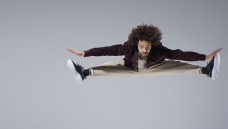 Mid-Shot-of-Breakdancer-Doing-Jump-Splits-with-Copy-Space