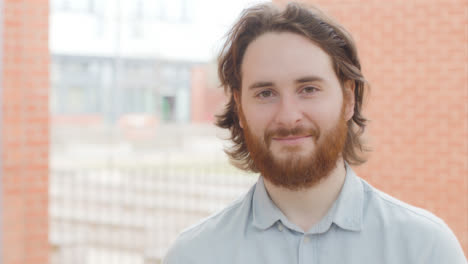 Portrait-Shot-of-Young-Man-In-Front-of-Brick-Walls