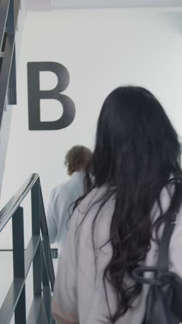 Vertical-Shot-of-Students-Walking-In-Stairwell-01