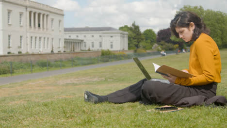 Wide-Shot-of-Young-Woman-On-Laptop-In-a-Park