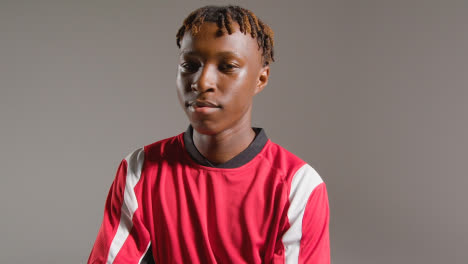 Studio-Portrait-Of-Young-Male-Footballer-Wearing-Club-Kit-1