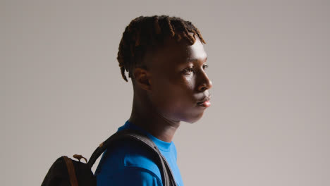 Studio-Shot-Of-Young-Man-Playing-Football-Or-Other-Sport-Walking-To-Training-With-Kit-Bag-